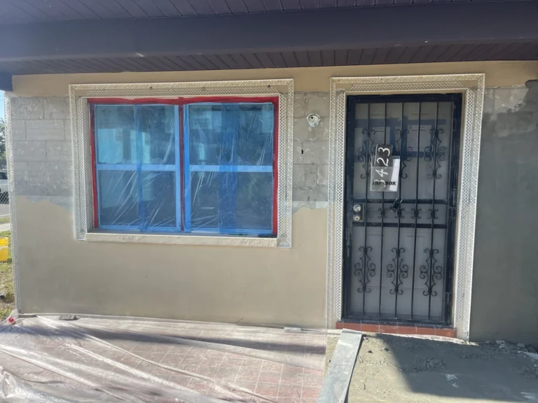 Close-up of fresh stucco with decorative molding around window and door during exterior home renovation, Tampa Bay FL — Power Contractor Group, CGC1539545
