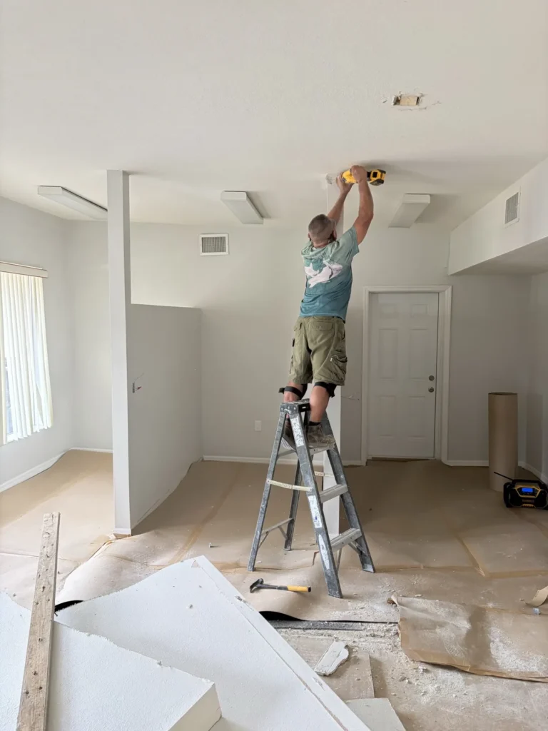 Contractor working on ceiling repair during interior home renovation with power drill, Tampa Bay FL — Power Contractor Group, CGC1539545