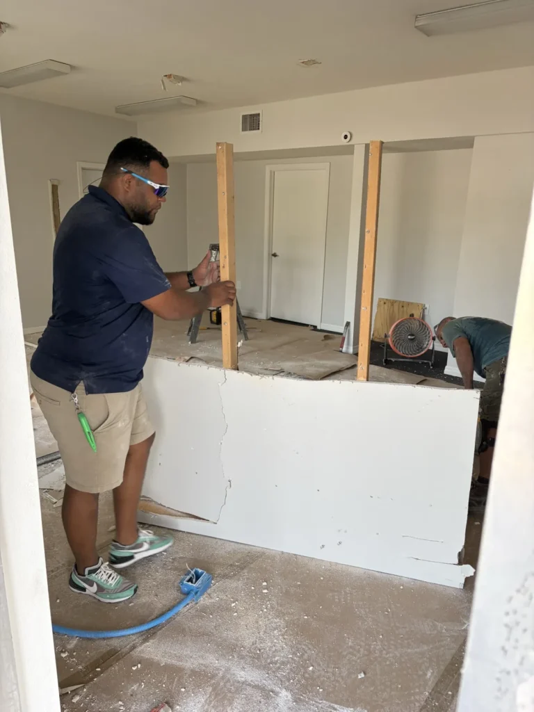 General contractor team removing partition wall and installing new framing during interior home renovation, New Port Richey FL — Power Contractor Group