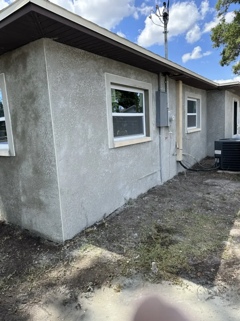 Completed room addition with fresh stucco exterior walls and new windows installed on residential home, Tampa Bay FL — Power Contractor Group, CGC1539545
