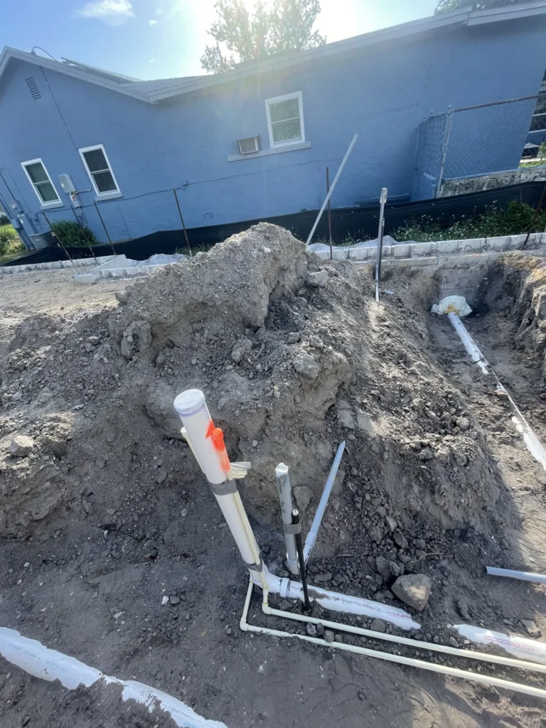 Aerial view of underground PVC rough-in plumbing network at new residential construction site in Tampa Bay, FL — Power Contractor Group, CFC1434028