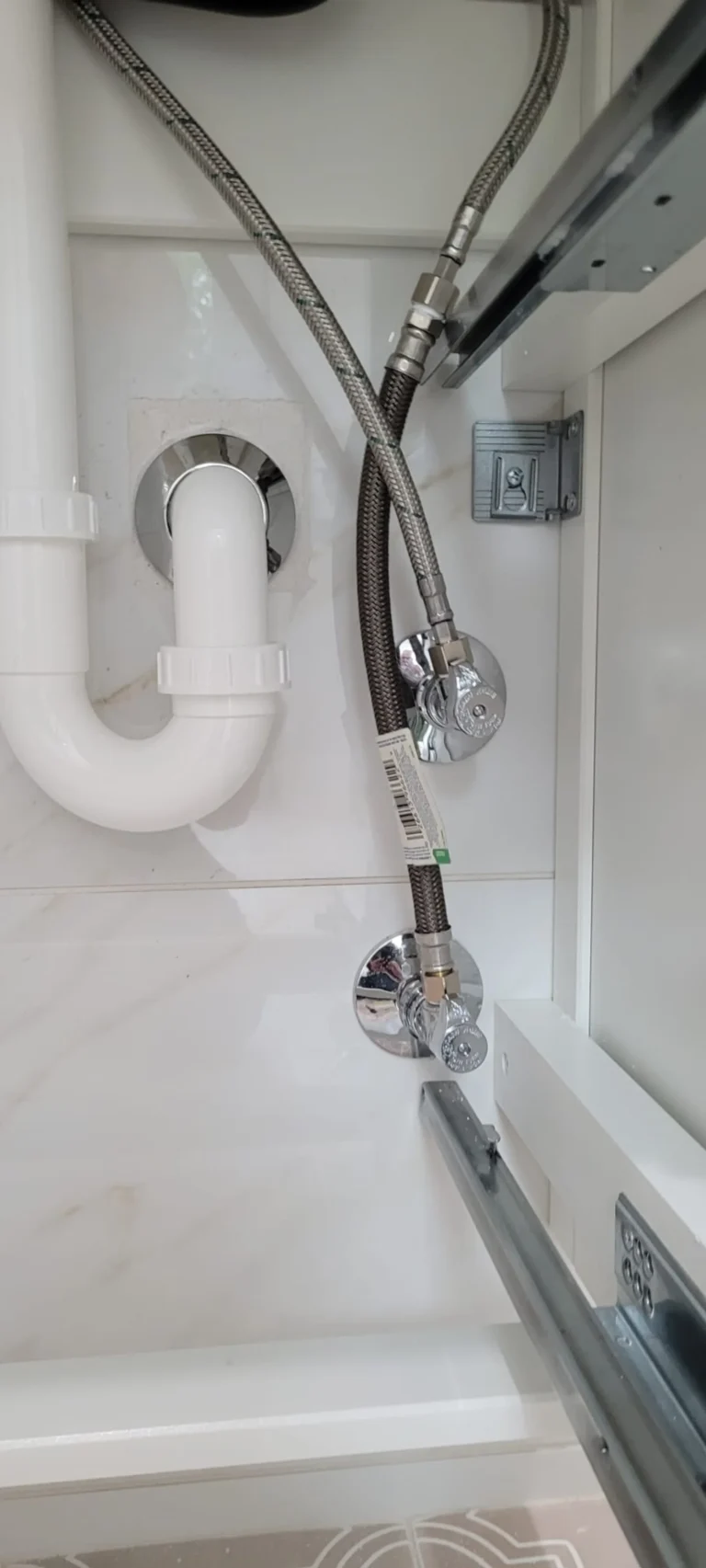 Under-cabinet P-trap drain and chrome shutoff valve supply line installation for bathroom fixture, Tampa Bay FL — Power Contractor Group, CFC1434028