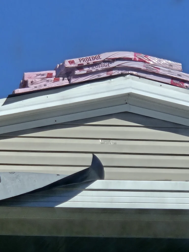 Licensed roofing contractor placing ProEdge shingles on a residential roof ridge in New Port Richey, FL — Power Contractor Group, CCC1337097